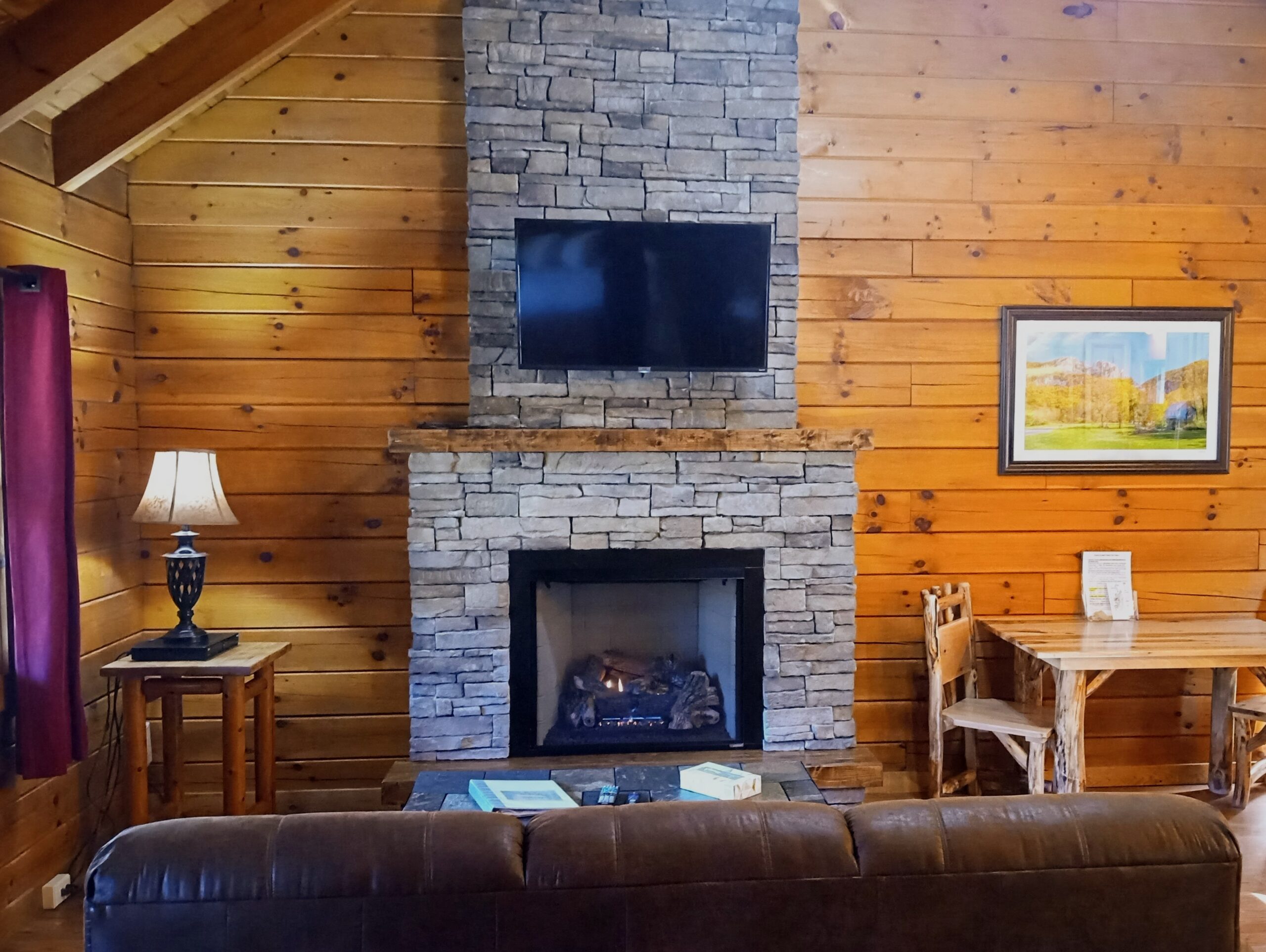 Stone fireplace in a West Virginia log cabin.