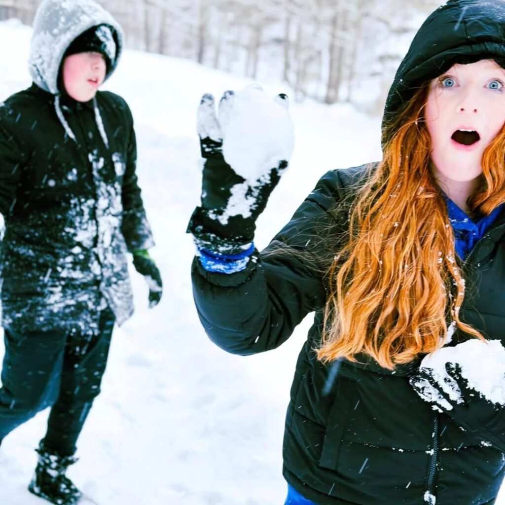 Harman's Log Cabins guests playing in the snow.